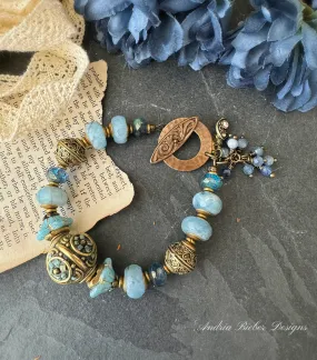 Aquamarine stone, African brass, Czech glass, Indonesian bead with flower detail.